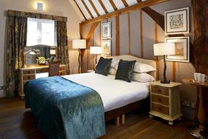 a bedroom with a bed and a desk and a window at Sir Christopher Wren Hotel in Windsor