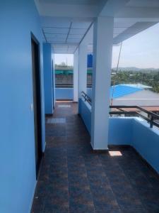 a hallway of a building with a view of a pool at Malar inn in Port Blair