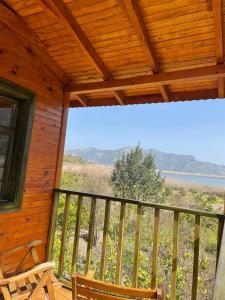 a porch of a cabin with a view of the ocean at Lake Wood House in Muğla
