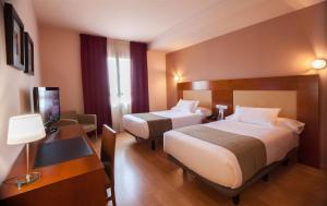 Giường trong phòng chung tại Hotel Andia