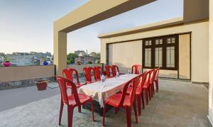 a table and chairs on a patio with a balcony at Itsy By Treebo - Amrita in Jammu