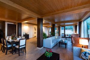 a living room with a couch and a table at StayVista at The Winter Line with Complimentary Breakfast in Kasauli