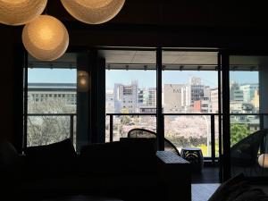 a view of a city skyline from a room with windows at Rinn Gion Shirakawa in Kyoto