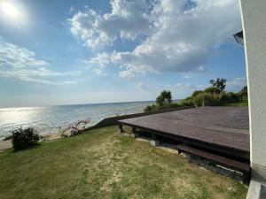 a picnic table on the side of a beach at ゴールデンマイルヴィラ in Amami