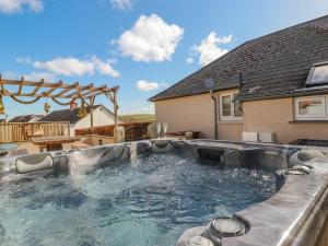 a swimming pool in the backyard of a house at Penlaurel in Bude
