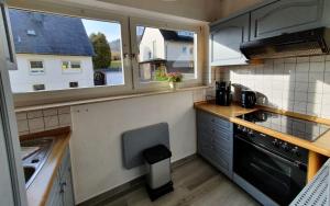 a small kitchen with a sink and a stove at Apartement Willingen in Stryck