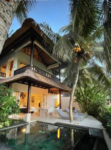 a villa with a swimming pool and a house at Crescent Moon in Ubud
