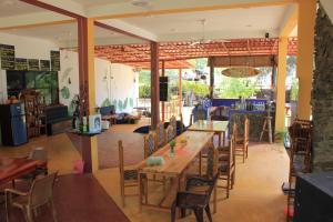 a dining room with a table and chairs at Sand Dune Beach Hotel & Surf Camp in Arugam Bay