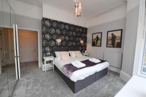 a bedroom with a bed with two towels on it at Harrogate Self Catering -Courtyard Mews - Garden in Harrogate