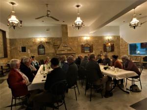 a group of people sitting at tables in a restaurant at Costas Inn in Spílion