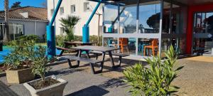 a picnic table in front of a house at hotelF1 Fréjus Roquebrune sur Argens in Roquebrune-sur-Argens
