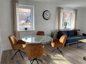 a living room with a glass table and chairs at Appartments Eutiner Seepark in Eutin