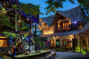 a house in a resort at night at Makofi Guest House in Nungwi