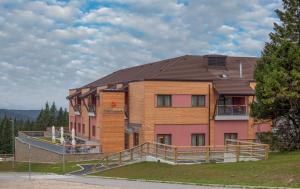 a large building with a brown roof at Hotel Natura in Zreče