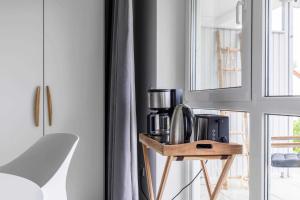 a kitchen with a coffee maker on a wooden stand at Haus Seeblick Wohnung 04 in Wohlenberg