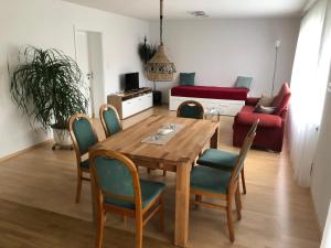 a living room with a wooden table and chairs at Ferienwohnung Beate in Höchst