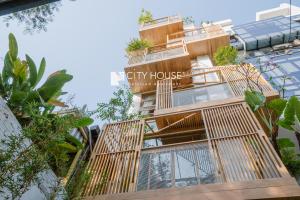 a building with a spiral staircase in front of it at Cityhouse - Ariosa in Ho Chi Minh City