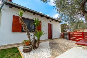 a house with palm trees in front of it at House 1119 in Muntić