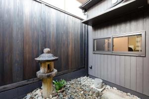 a fire hydrant in front of a house at Daisenji Lodge Ing 藍 地下鉄鞍馬口駅から徒歩1分 in Kyoto