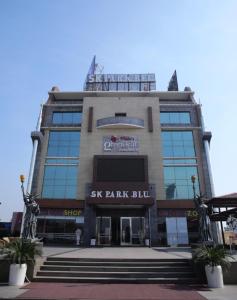 a large building with a sign on the front of it at SK Park Blu in Sonīpat