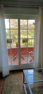 a room with a sliding glass door with a view of a patio at Apartamento Ayamonte Isla Canela Golf in Ayamonte