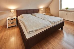 een slaapkamer met een groot bed en 2 nachtkastjes bij Strandmuschel in Zingst