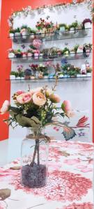 a glass vase filled with flowers on a table at The Floral Home in Melaka