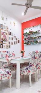 a dining room with a white table and chairs at The Floral Home in Melaka