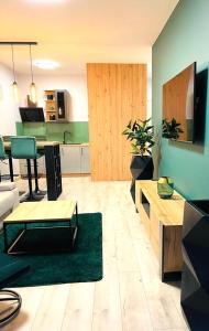 a living room with a couch and a table at APARTAMENT ELEGANCE GREEN w Let's Sea in Gąski