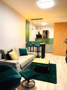 a living room with a couch and a table at APARTAMENT ELEGANCE GREEN w Let's Sea in Gąski