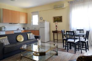 a living room with a couch and a table at Delmare Dion apartment in Thessaloniki