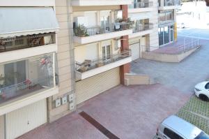 an apartment building with balconies and a parking lot at Delmare Dion apartment in Thessaloniki