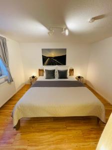 a bedroom with a large bed and a window at Strandapartment in Westerland für 2-4 Personen in Westerland