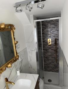 a bathroom with a sink and a shower with a mirror at PARIOLI LUXURY SUITE in Rome