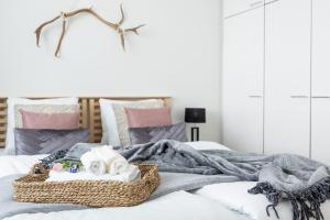 een mand met handdoeken en handdoeken op een bed bij Arctic Aurora City Suite in Rovaniemi