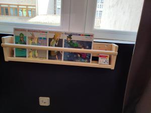 a book shelf on a wall with books on it at Hotel Cuéntame La Puebla in Burgos