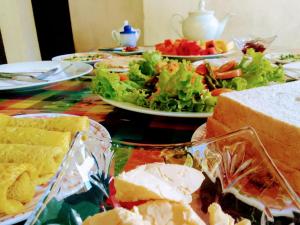 uma mesa coberta com pratos de comida e uma salada em Red Rose Ella em Ella