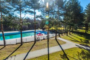 an overhead view of a swimming pool in a park with trees at Hotel Dobczyce in Dobczyce