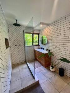 a bathroom with a shower and a sink at Tranquil Rainforest Studio Kuranda in Kuranda