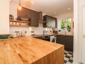 a large kitchen with a wooden counter top at 'Riverside' Summercourt in Penryn