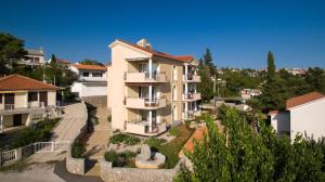 a large building in the middle of a city at Marija F2 Apartment in Krk
