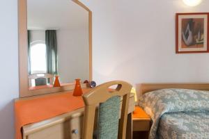 a bedroom with a bed and a mirror at Marija F2 Apartment in Krk +10 photos