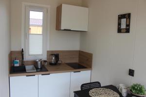 a kitchen with a counter and a sink and a window at Marina Houses in Ruciane-Nida