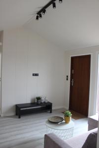 a living room with a table and a brown door at Marina Houses in Ruciane-Nida +27 photos