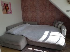 a bedroom with a bed and a couch in it at Altastenberger Lodge in Winterberg