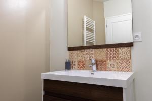 a bathroom with a white sink and a mirror at Le gite du Maréchal in Saint-Aignan +22 photos