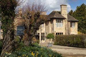 a brick house with a sign in front of it at The William Cecil in Stamford