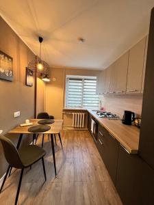 a kitchen with a table and some chairs and a table and a tablektop at Draudzības alejas apartamenti in Jēkabpils