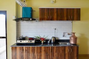 a kitchen with a sink and a stove at Garden Rest House in Pokhara