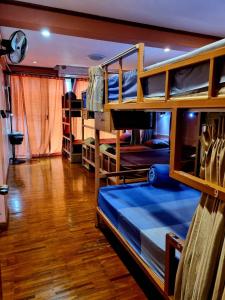 a room with several bunk beds in a house at T2B Hostel in Chiang Mai